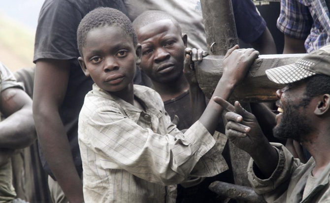 Boys working as artisanal miners take a break from panning for gold at the Marco gold mine in Mukungwe locality in Walungu territory of South Kivu